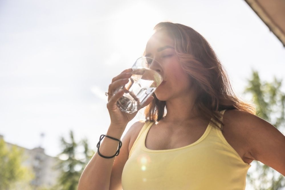 Runner drinking water on a hot summer day