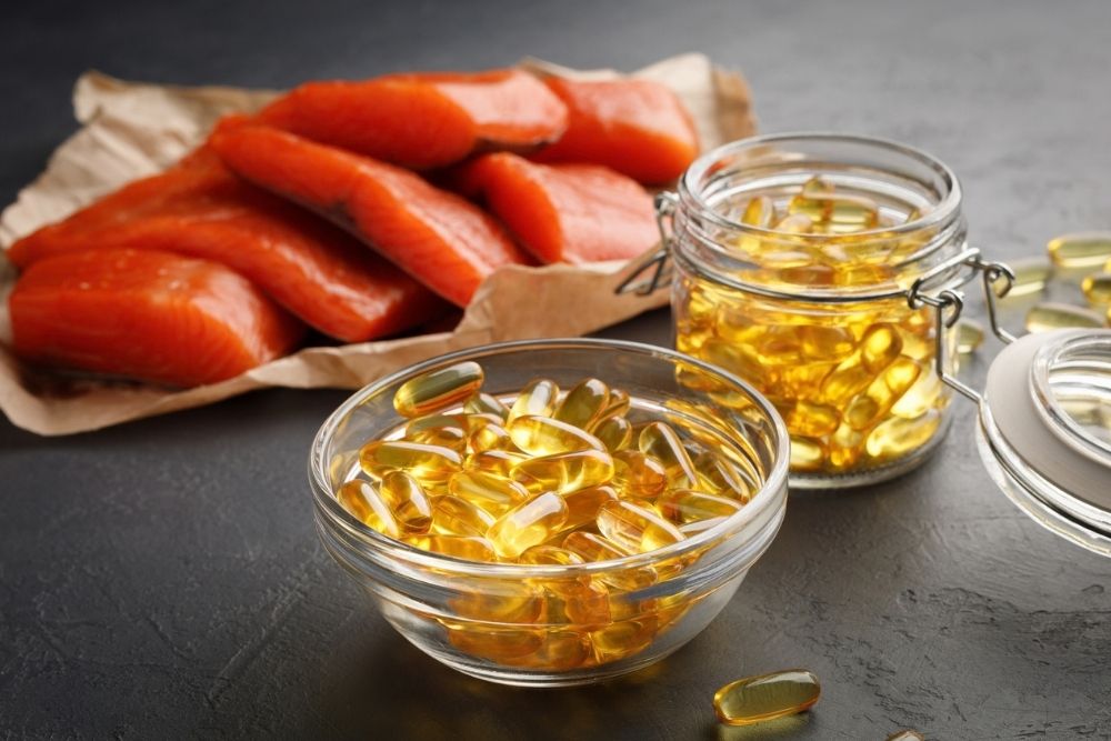 Fish oil capsules with salmon and omega-3 rich foods Fish oil capsules with salmon and omega-3 rich foods