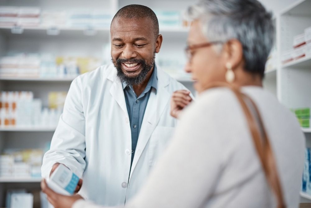 Pharmacist talking with an older woman about her medications