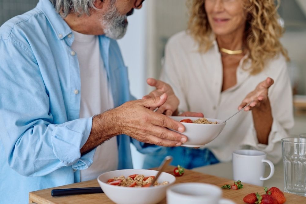 Older couple sharing a healthy breakfast in the kitchen