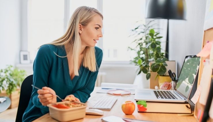 Busy professional eating lunch while working Busy professional eating lunch while working